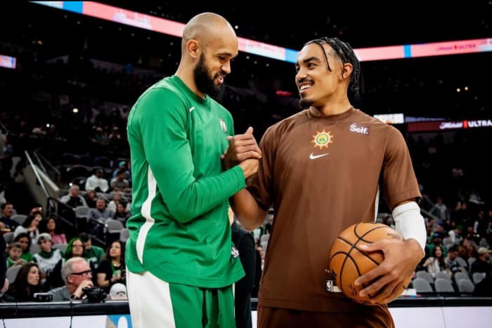 Dec 31, 2023; San Antonio, Texas, USA; San Antonio Spurs guard Tre Jones (right) speaks with former teammate Derrick White ahead of his team's matchup against the Boston Celtics.
